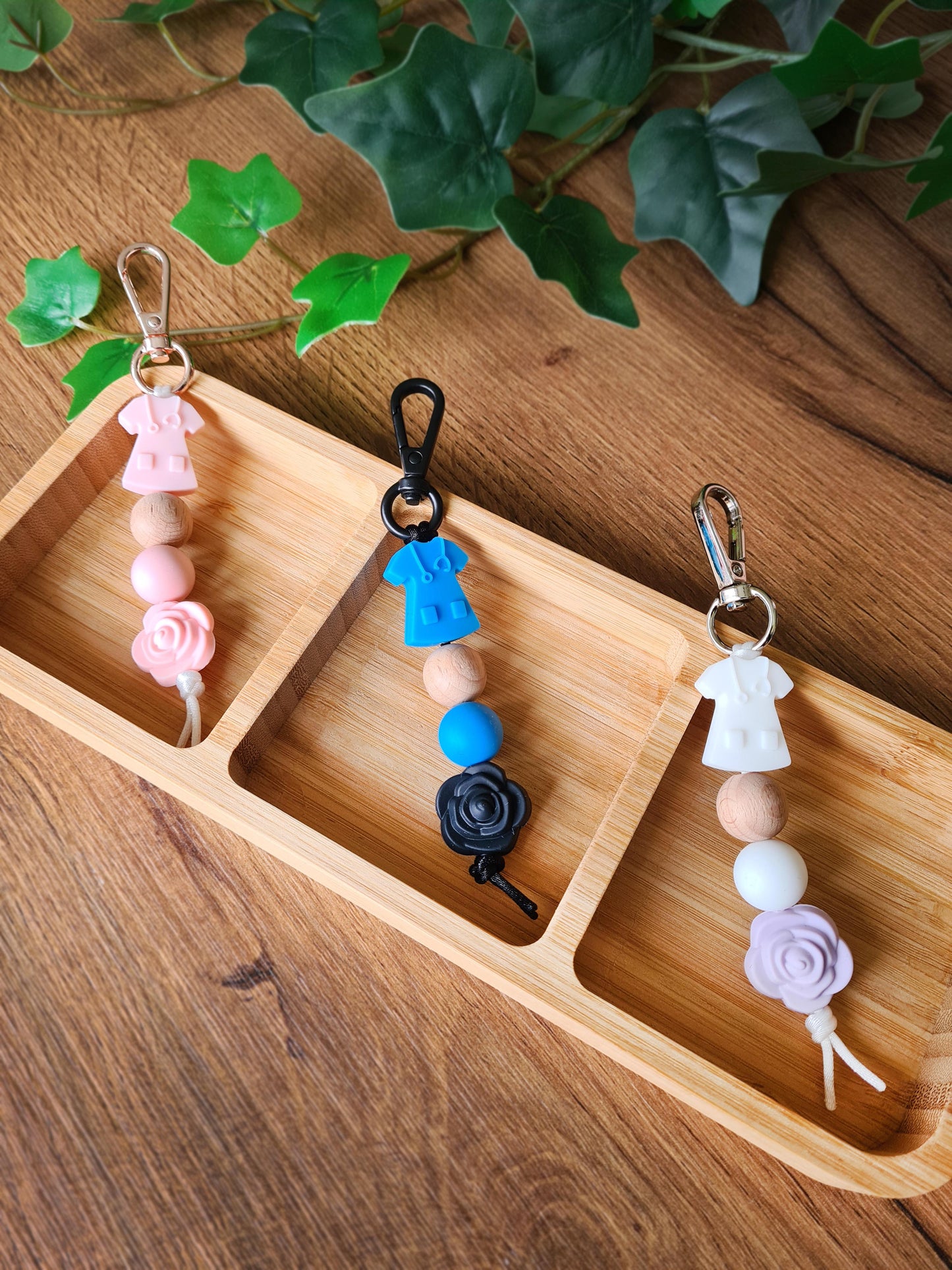 Our handmade keychains make the perfect gift for those amazing medical people in our lives. This keychain / zip puller comes with a pink scrub shaped bead.