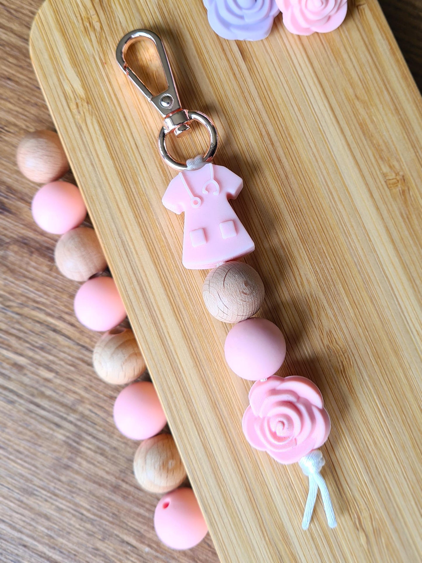 Our handmade keychains make the perfect gift for those amazing medical people in our lives. This keychain / zip puller comes with a pink scrub shaped bead.