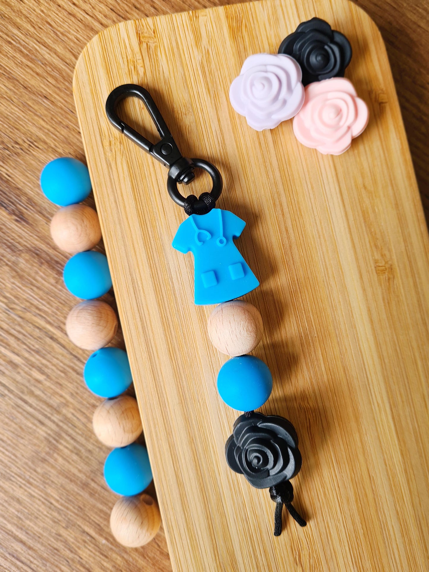 Our handmade keychains make the perfect gift for those amazing medical people in our lives. This keychain / zip puller comes with a blue scrub shaped bead.