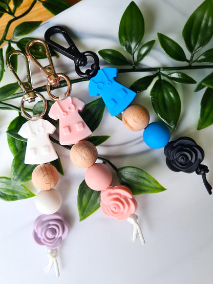 Our handmade keychains make the perfect gift for those amazing medical people in our lives. This keychain / zip puller comes with a white scrub shaped bead.