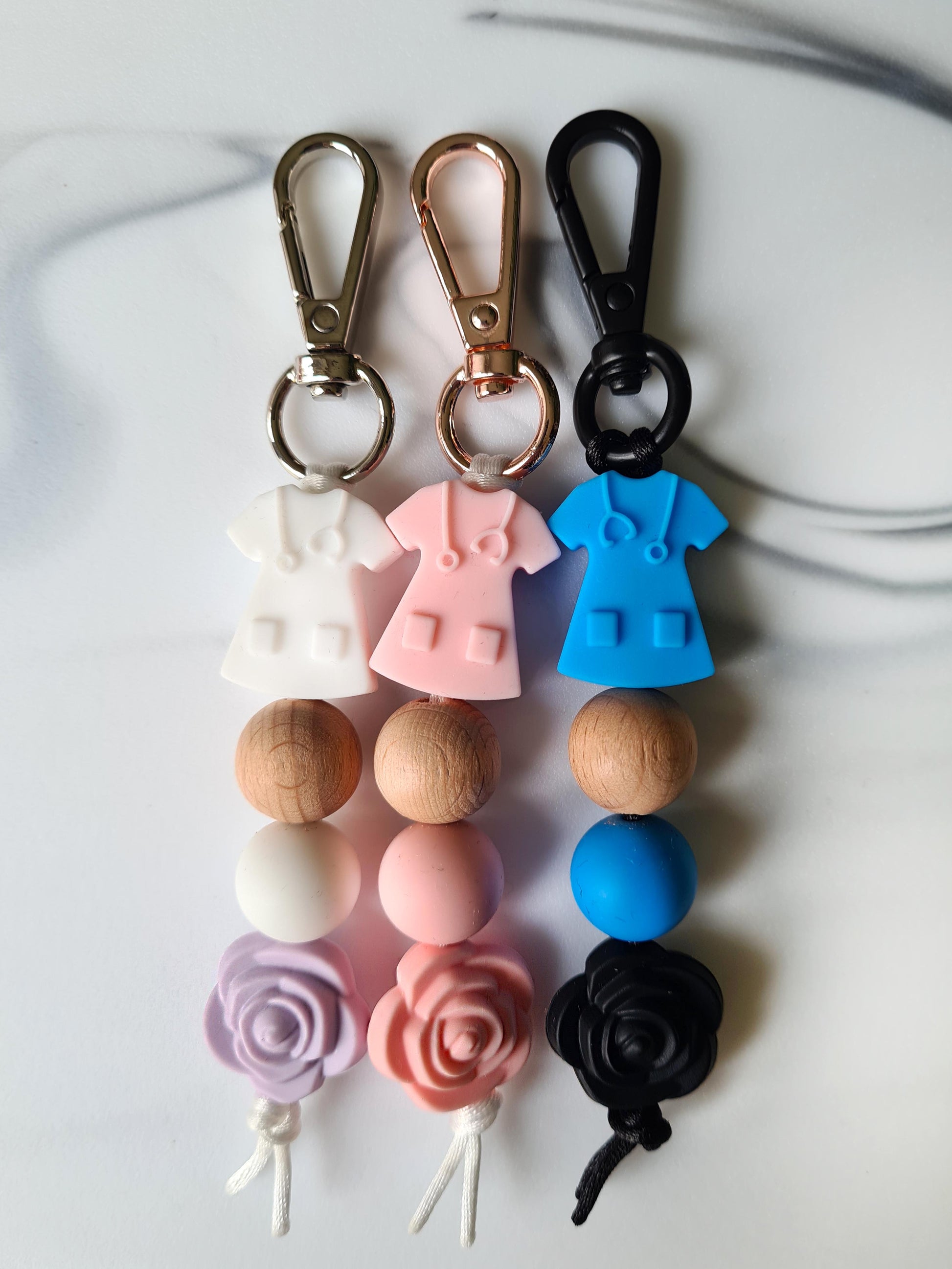 Our handmade keychains make the perfect gift for those amazing medical people in our lives. This keychain / zip puller comes with a pink scrub shaped bead.