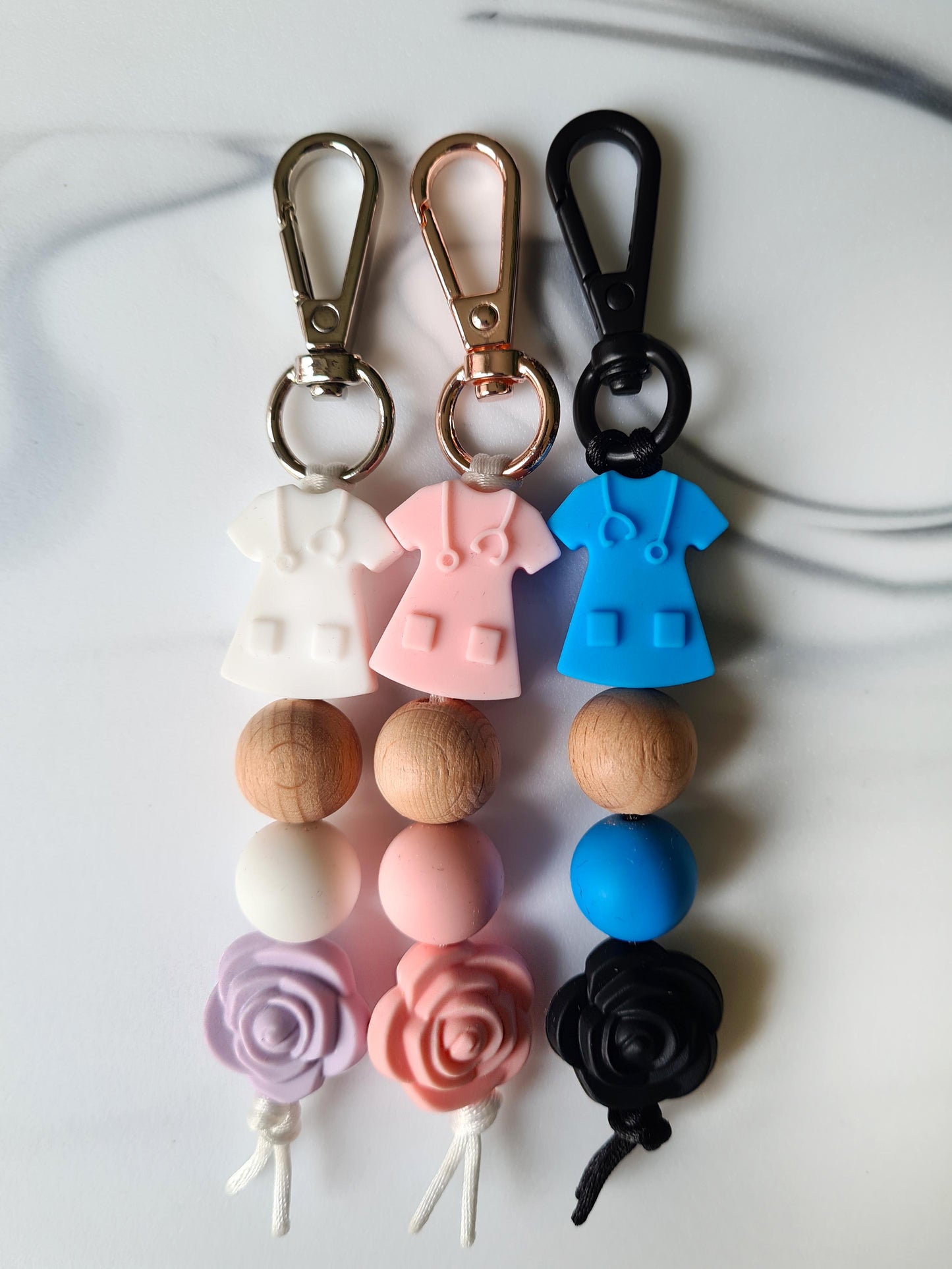 Our handmade keychains make the perfect gift for those amazing medical people in our lives. This keychain / zip puller comes with a blue scrub shaped bead.