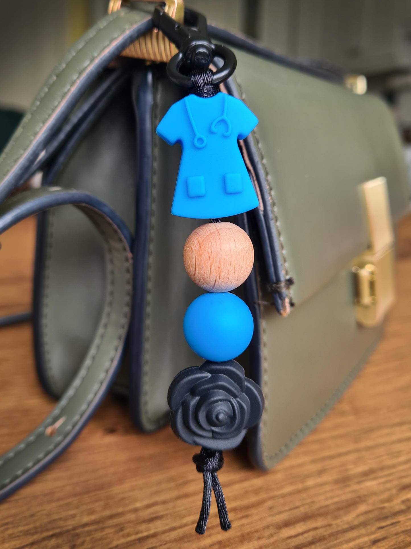 Our handmade keychains make the perfect gift for those amazing medical people in our lives. This keychain / zip puller comes with a blue scrub shaped bead.