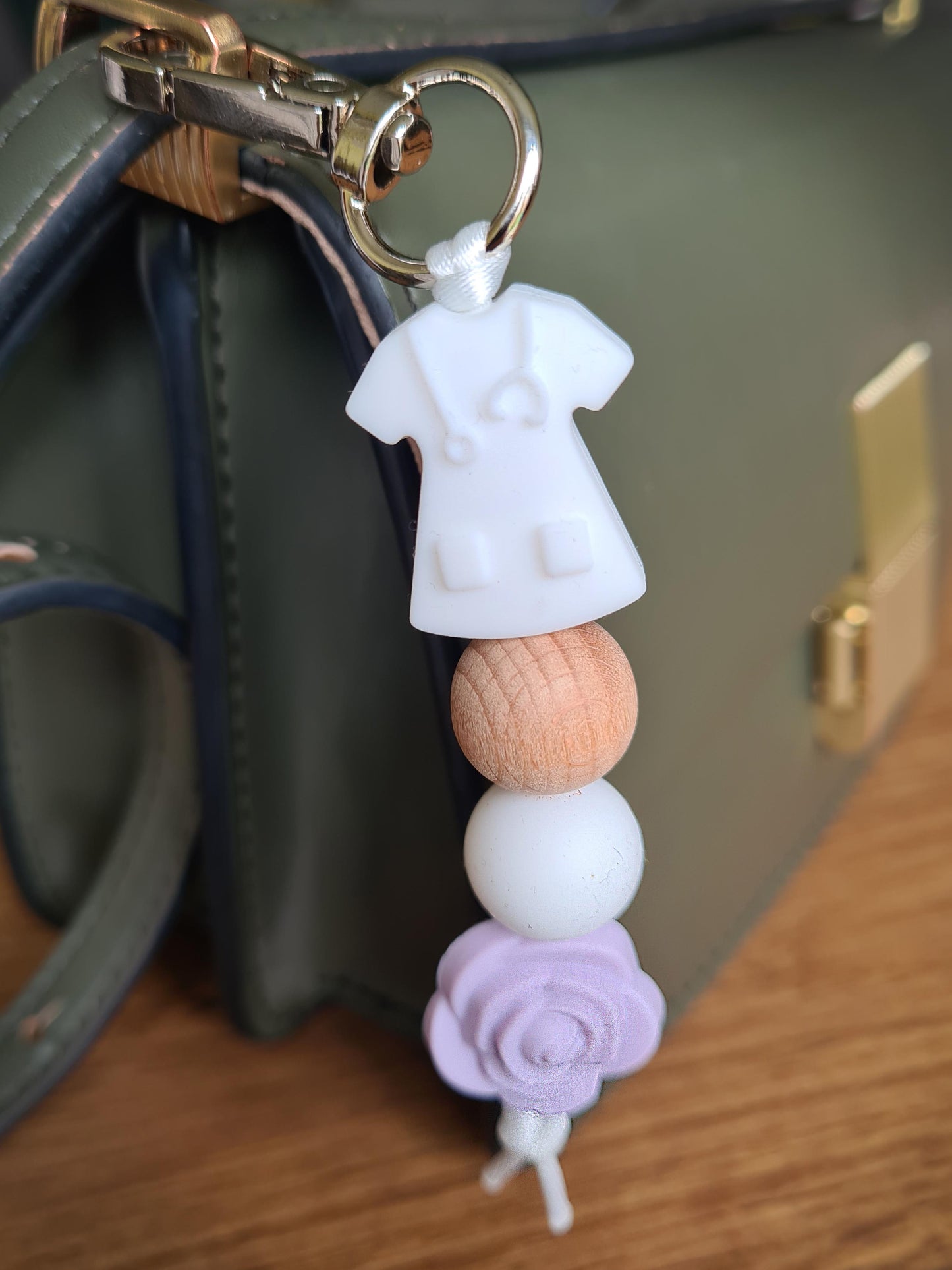 Our handmade keychains make the perfect gift for those amazing medical people in our lives. This keychain / zip puller comes with a white scrub shaped bead.