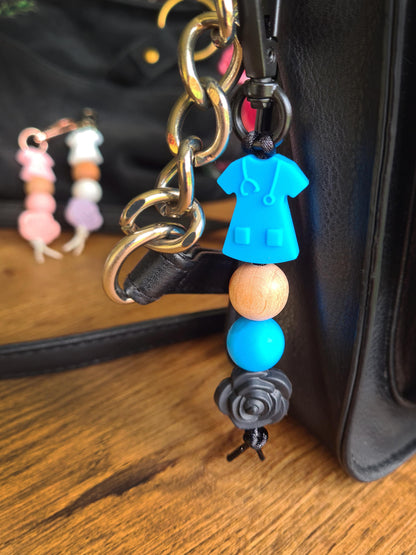 Our handmade keychains make the perfect gift for those amazing medical people in our lives. This keychain / zip puller comes with a blue scrub shaped bead.