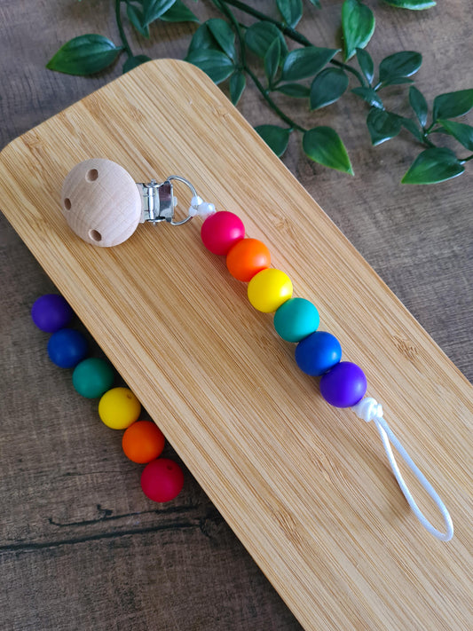 Cute handmade soother clip. Unique gift ideas for newborns and toddlers. Handcrafted Irish made. Rainbow coloured gift.