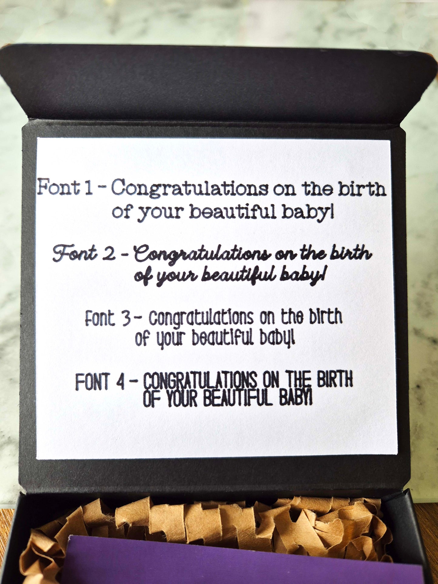 Card with different font styles for a baby congratulation message