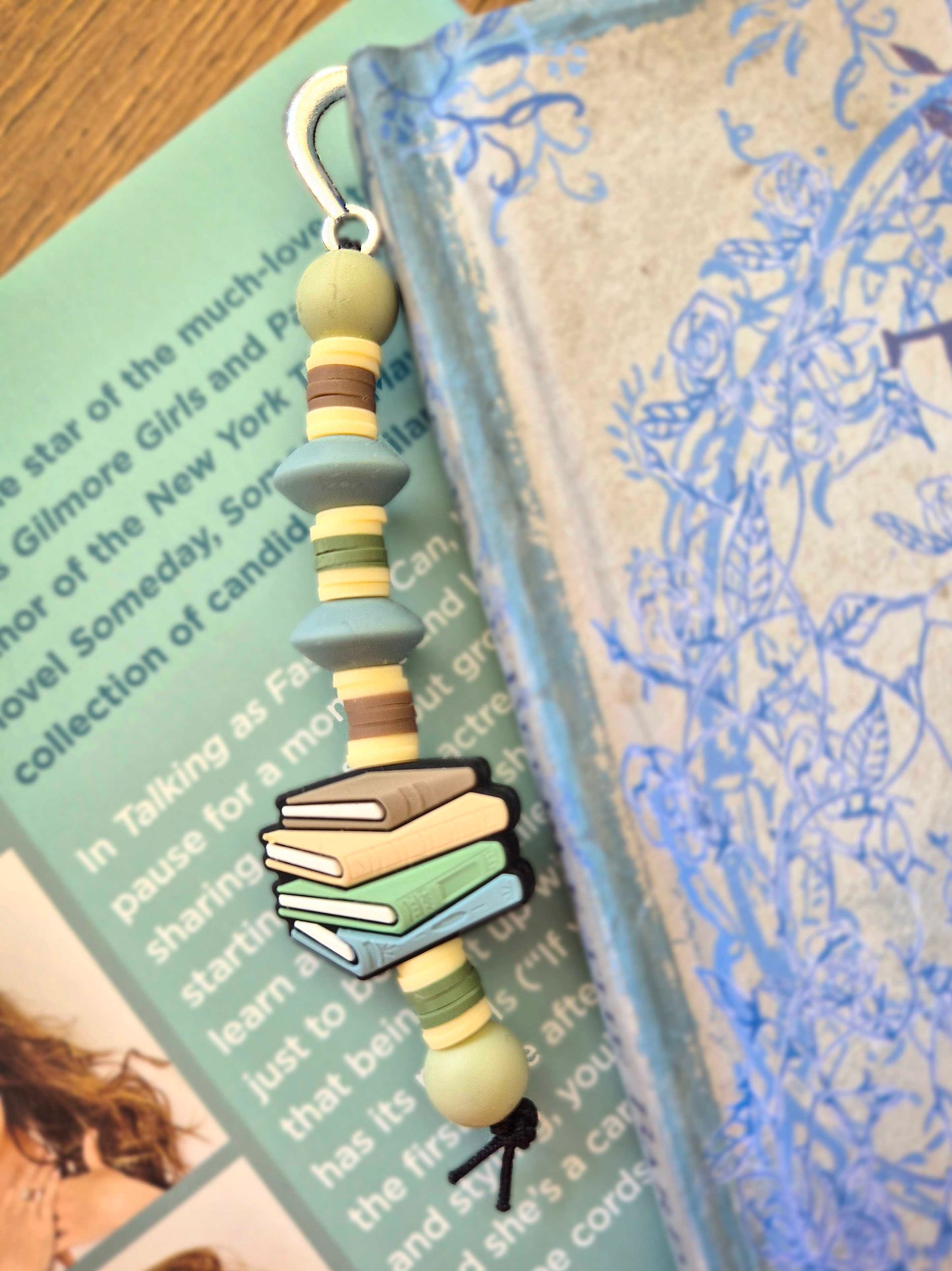 Silver feather bookmark decorated with beads. Stack of books as a focal bead.