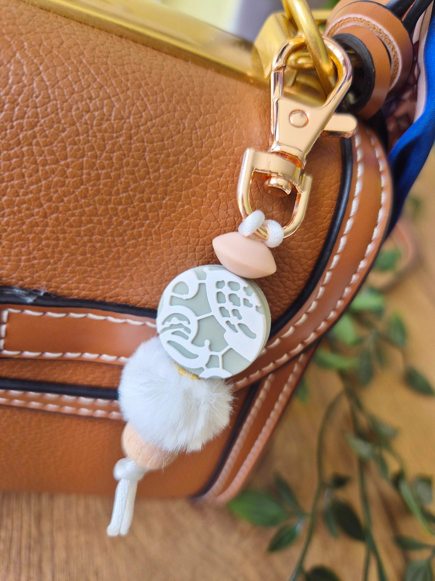 Keychain / Bag Decor / Zip Puller made of beech wood and silicone beads. Rose gold clip with sage focal bead and fluffy soft bead.
