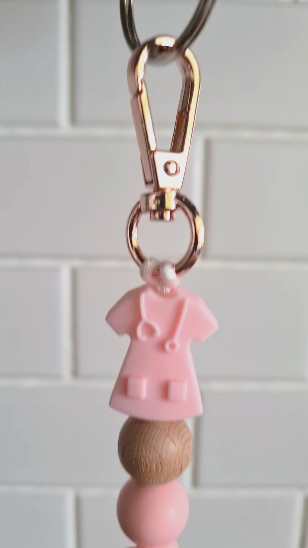 Our handmade keychains make the perfect gift for those amazing medical people in our lives. This keychain / zip puller comes with a pink scrub shaped bead.