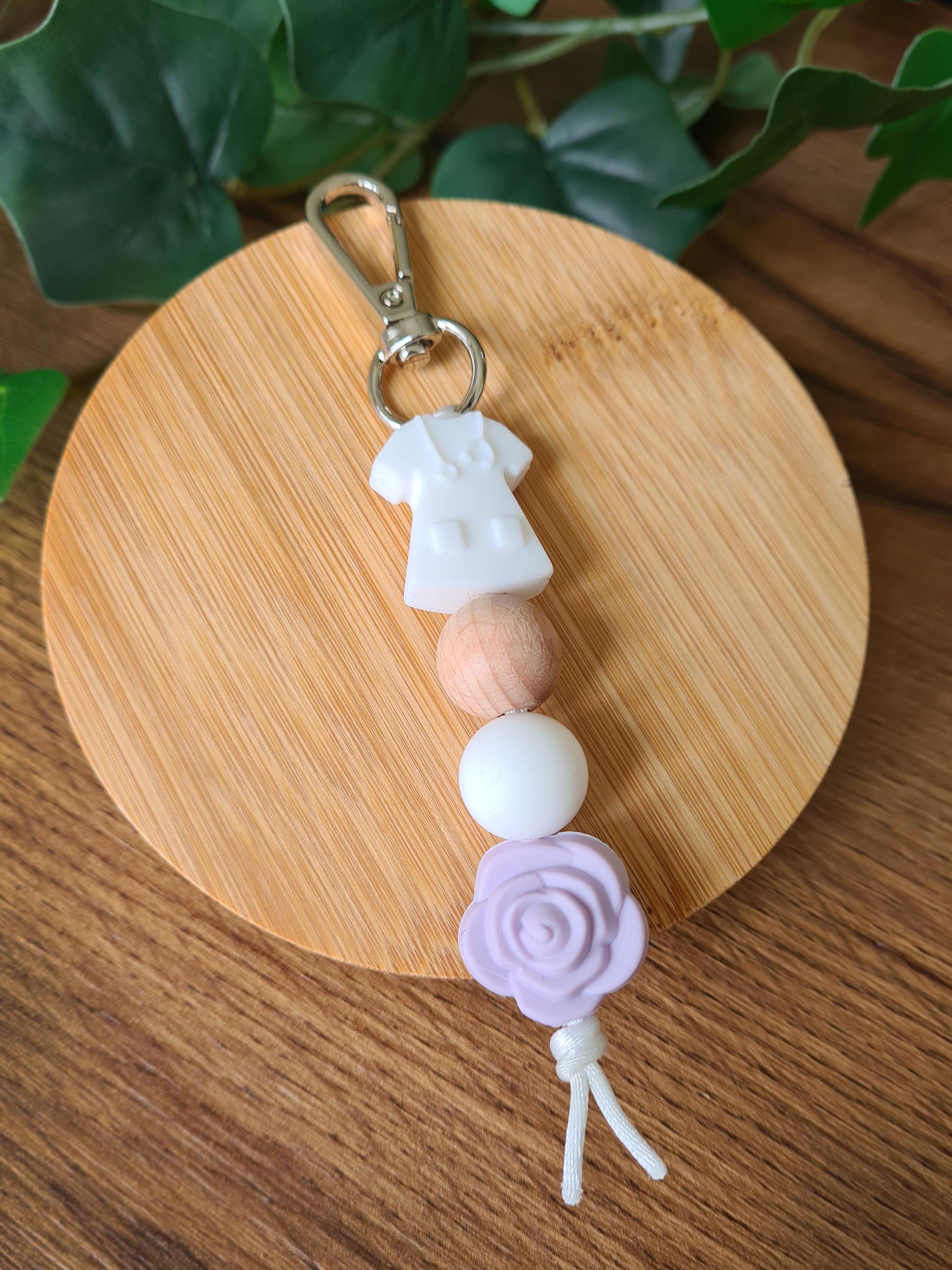 Our handmade keychains make the perfect gift for those amazing medical people in our lives. This keychain / zip puller comes with a white scrub shaped bead.