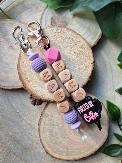 Two keychains, one purple and one pink, for Mama's.