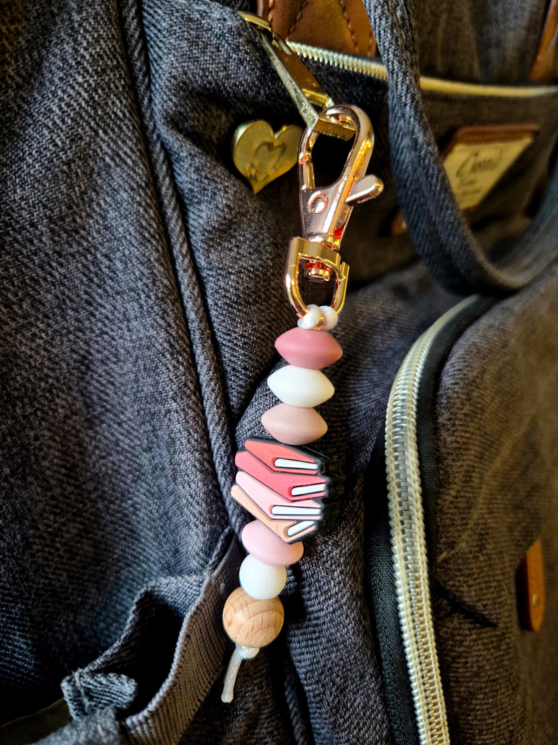 Pink Books Keychain on a backpack