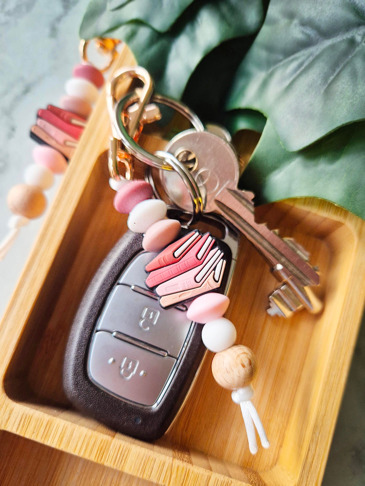 Pink Books Keychain in a dish
