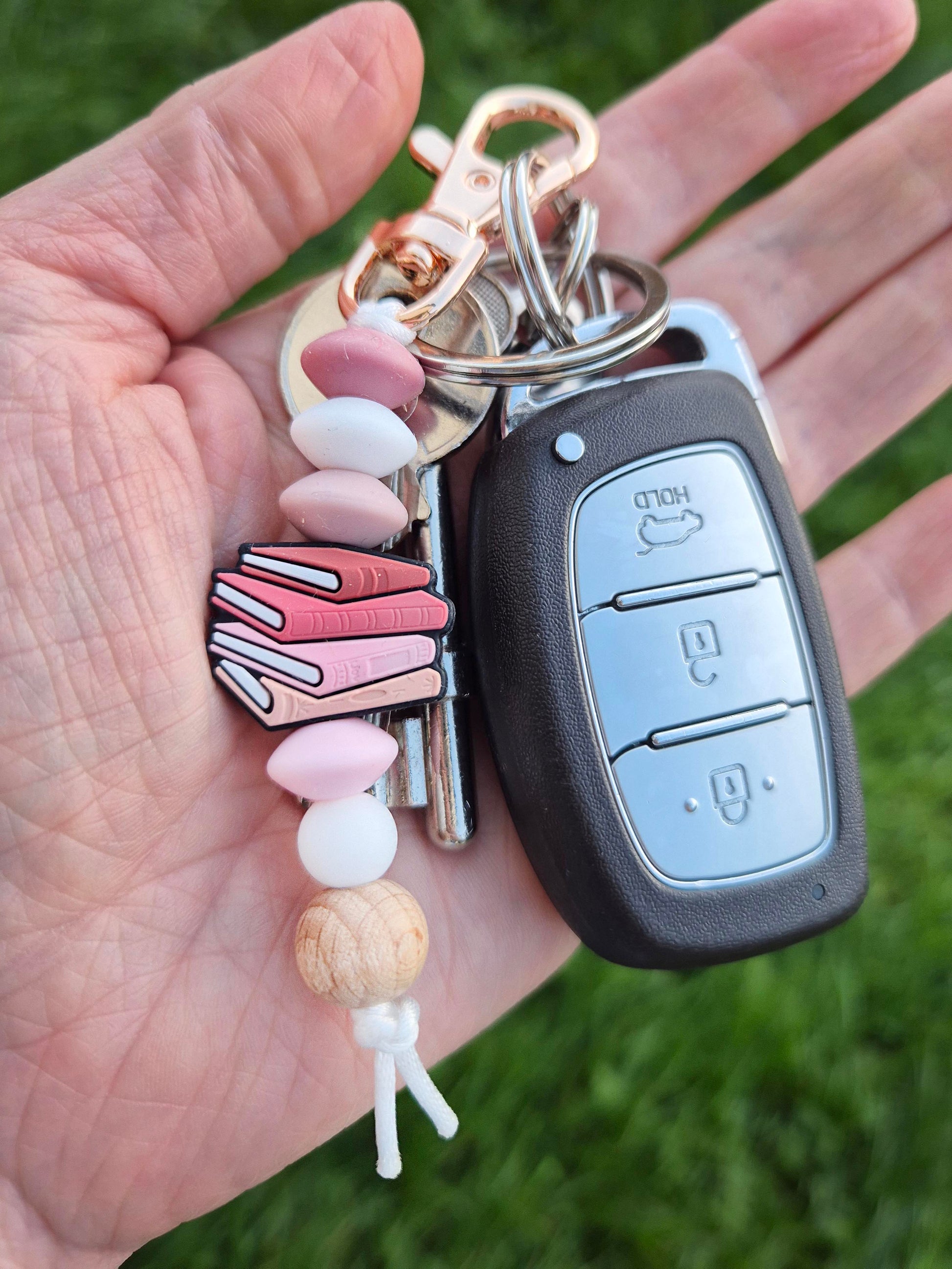Pink Books Keychain on a set of keys
