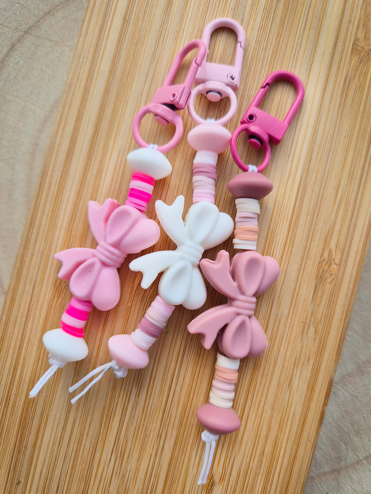 Bow-tiful bow keychains in white, light pink and dusty pink with striped heishi beads