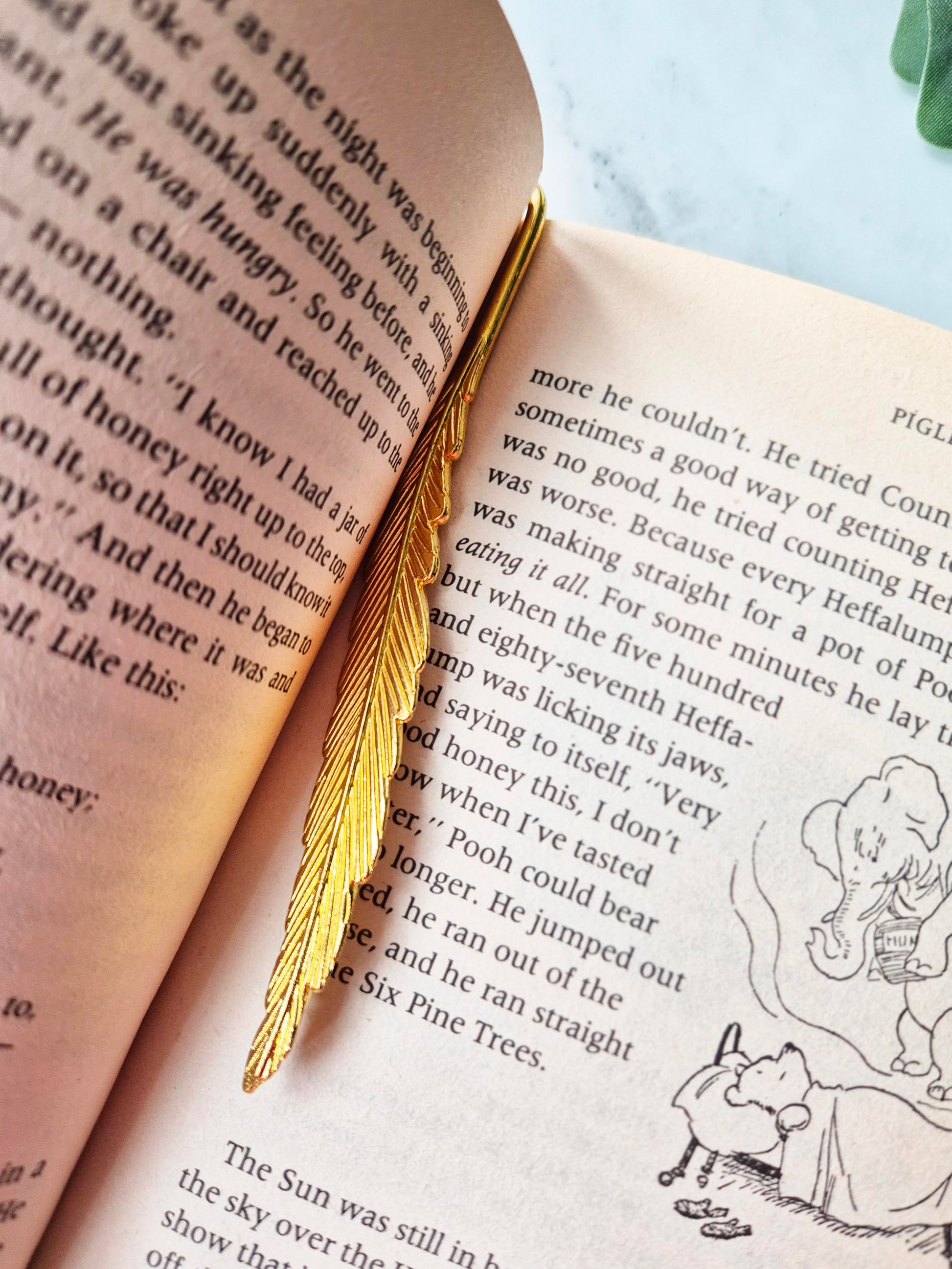 Gold Feather Bookmark in a book