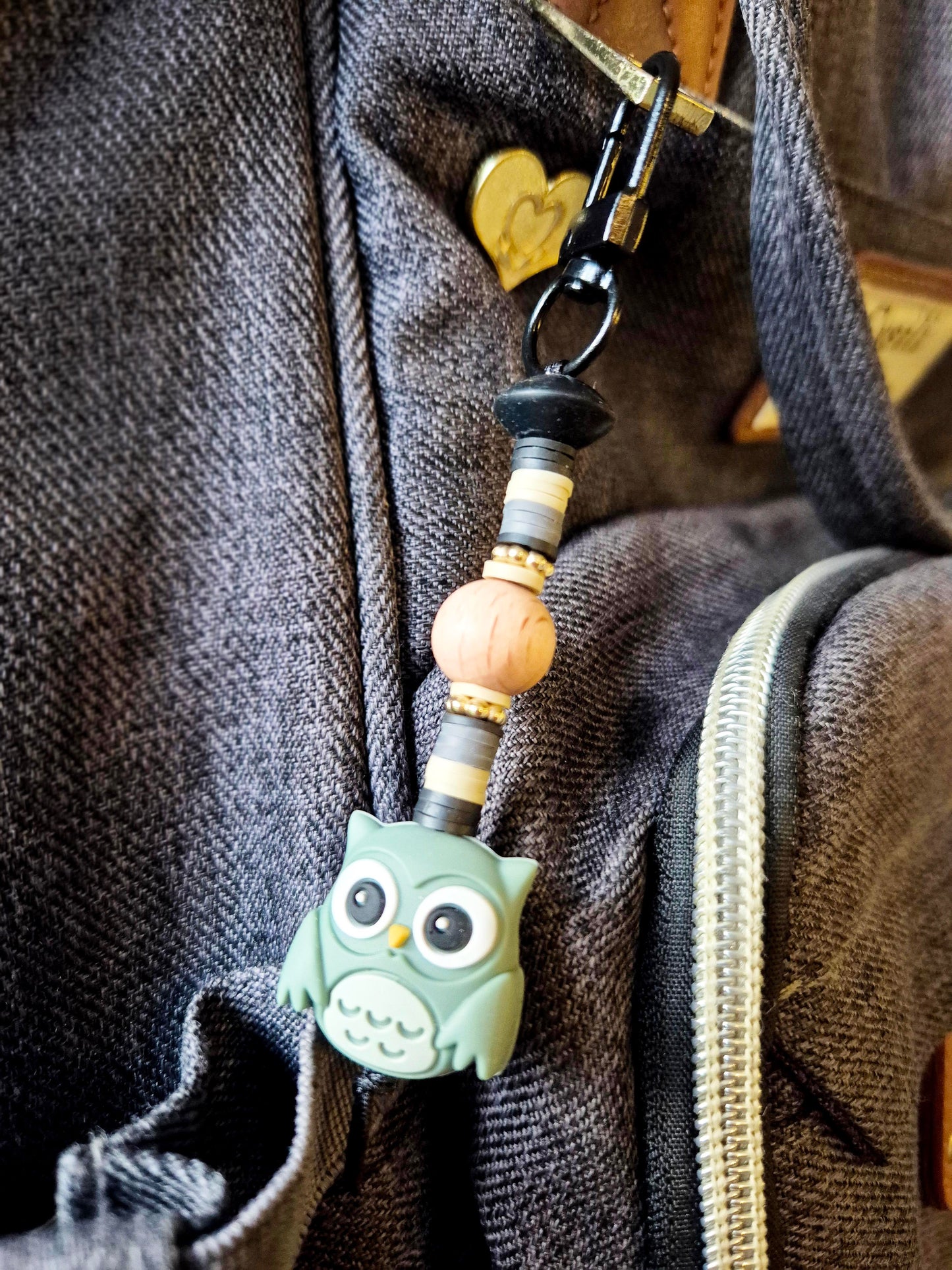 Green owl keychain on backpack