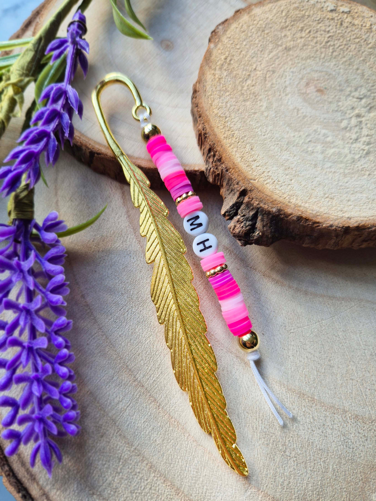 Gold feather metal bookmark with Pink beads and the letters MG
