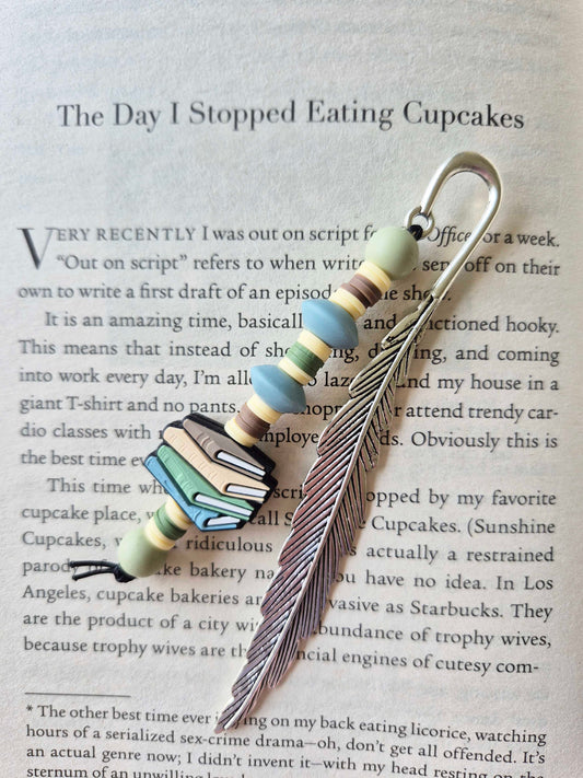 Silver feather bookmark decorated with beads. Stack of books as a focal bead.