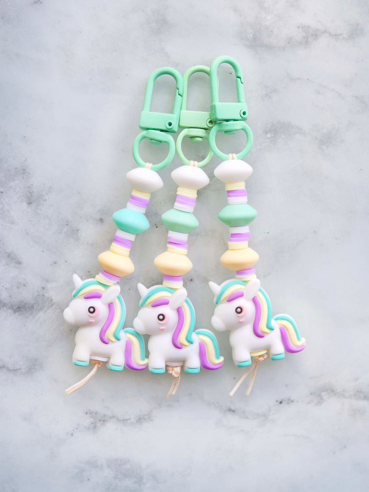 Handmade pastel unicorn beaded keychain zip puller in light pink and mint green