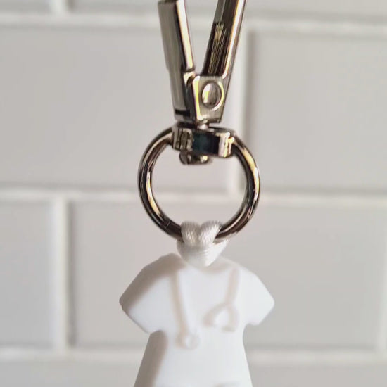 Our handmade keychains make the perfect gift for those amazing medical people in our lives. This keychain / zip puller comes with a white scrub shaped bead.