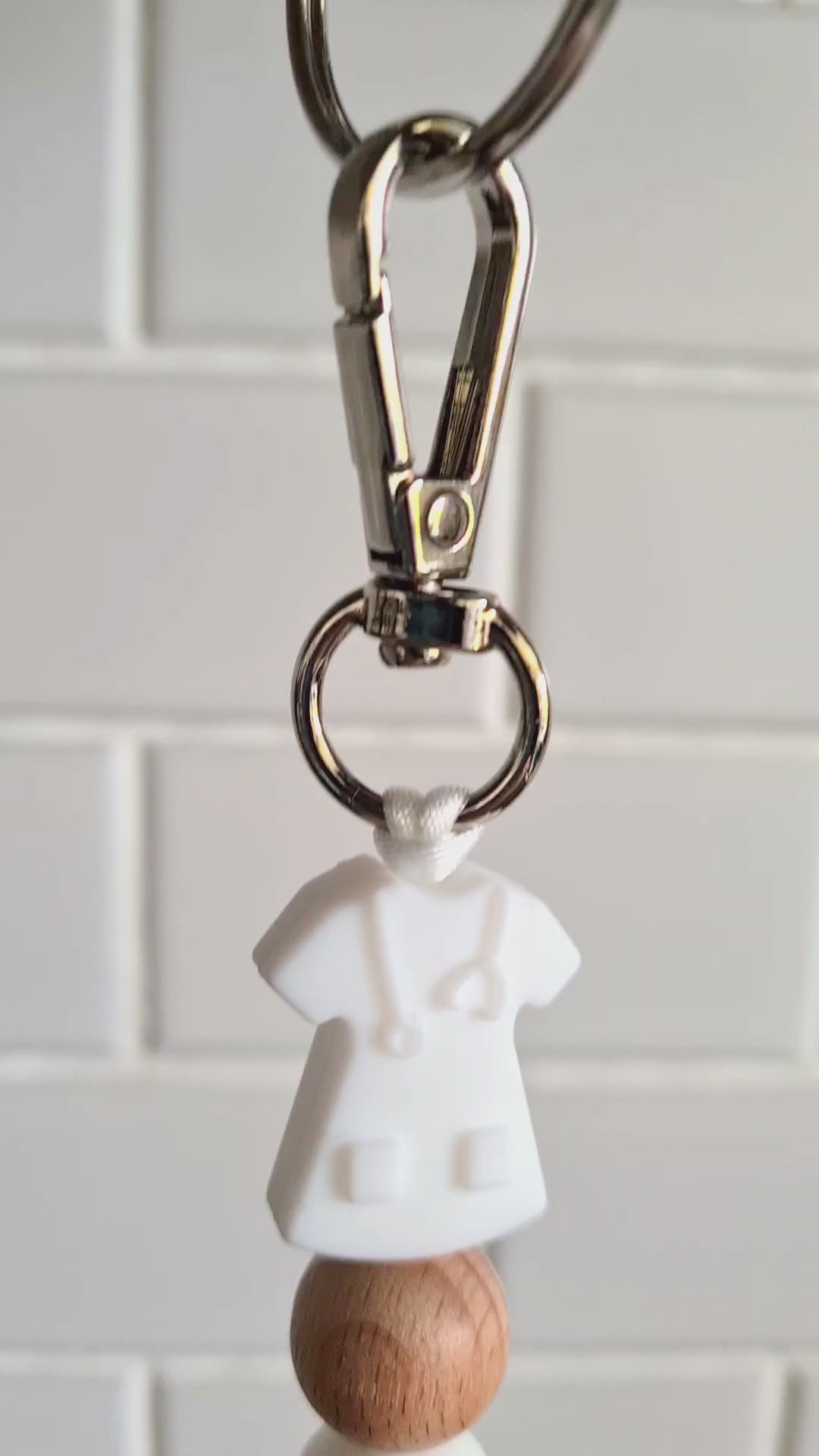 Our handmade keychains make the perfect gift for those amazing medical people in our lives. This keychain / zip puller comes with a white scrub shaped bead.